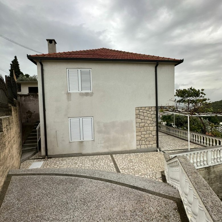 Exclusive Ulcinj property: two-story home with red-tiled roof, white walls, stone terraces. Listed on immorenta.me by Eksphere.