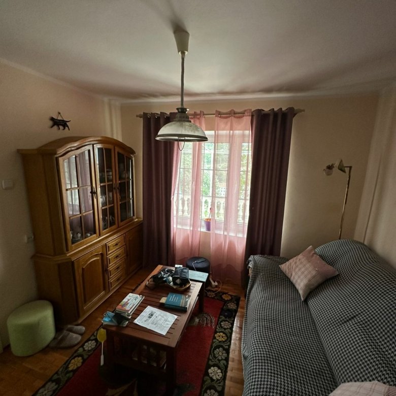 Elegant Ulcinj living room with wooden cabinet, stylish rug, cozy sofa, and natural light. Top Montenegro property by Ekosphere on immorenta.me.