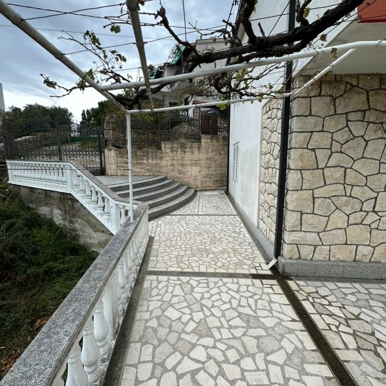Charming stone house in Ulcinj, Montenegro with stone walls, walkway, and vine trellis&mdash;exclusive at immorenta.me by Ekosphere DOO.