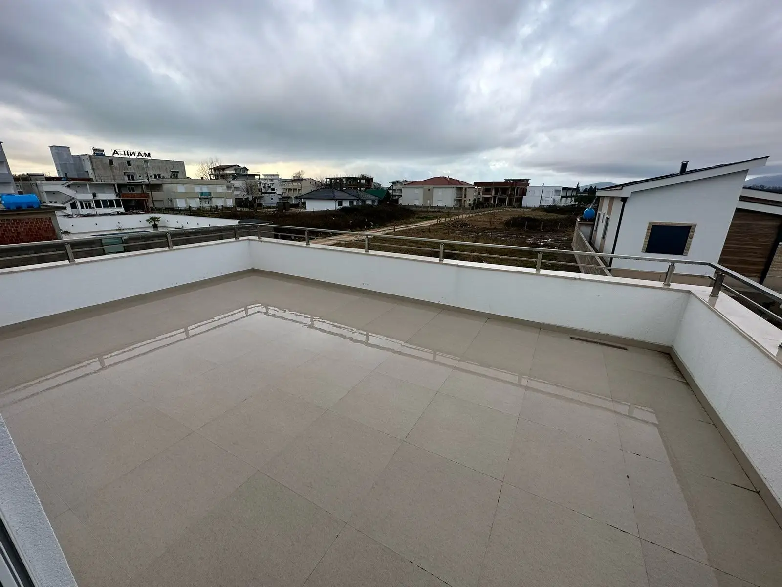 Spacious rooftop terrace with elegant tiles and modern railings, offering panoramic Ulcinj views&mdash;prime real estate at immorenta.me by ekosphere doo.