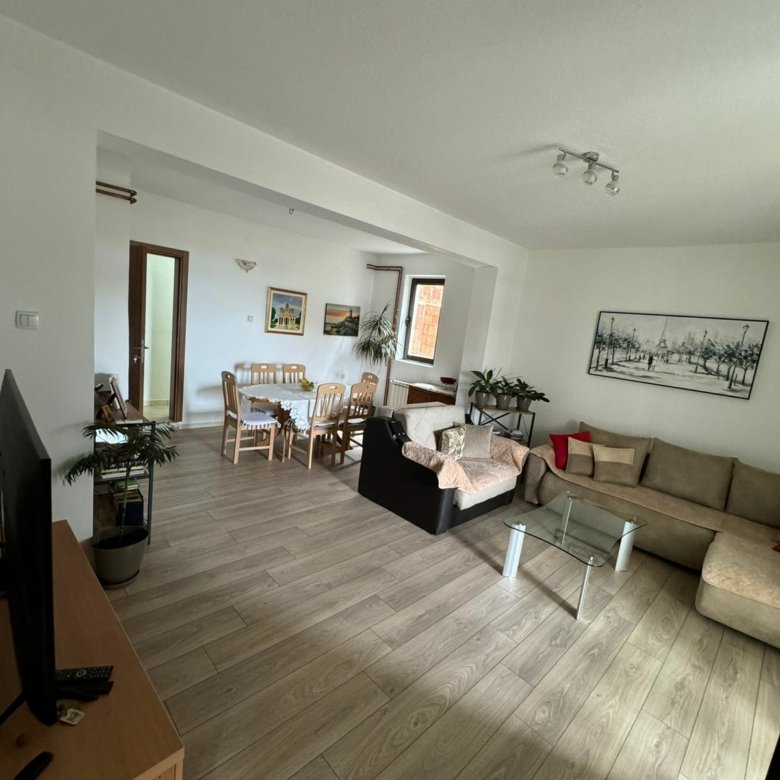Elegant Ulcinj apartment: light wood floors, beige sectional, eco accents. Premium comfort by ekosphere doo at immorenta.me.