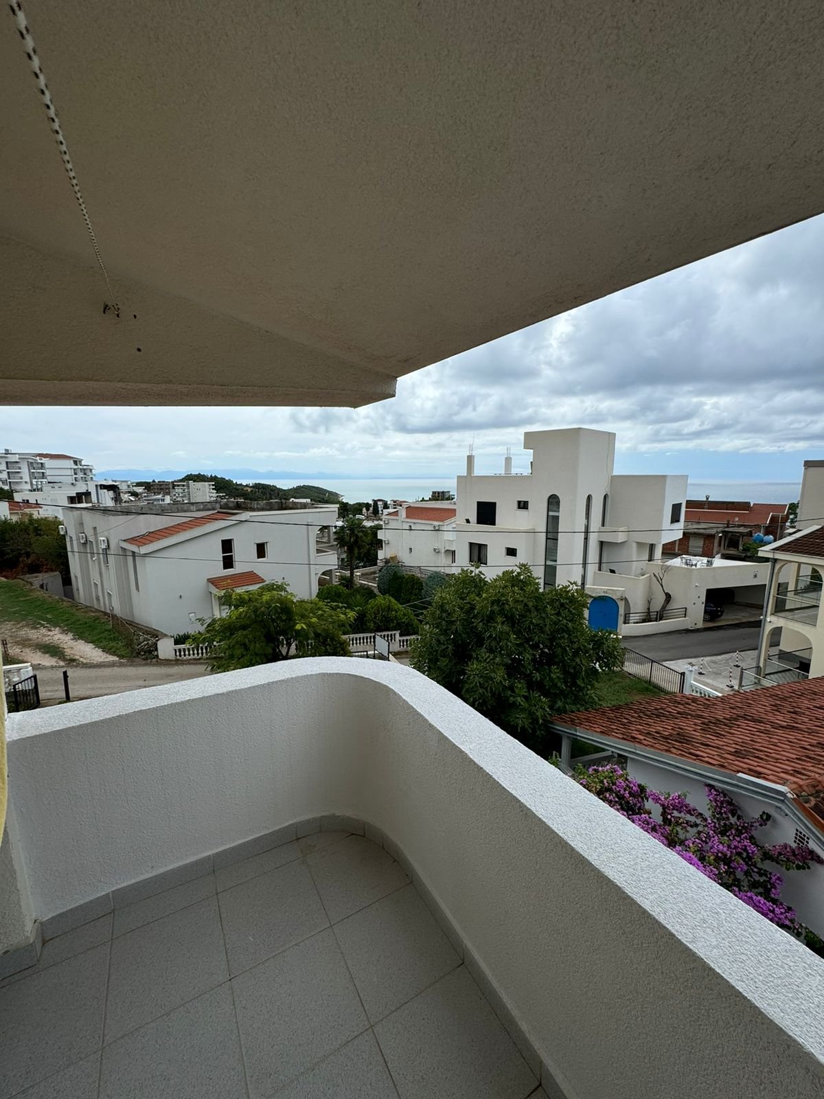 Modern tiled balcony with sea view, overlooking prime Ulcinj real estate. Invest in Montenegro&mdash;immorenta.me by Ekosphere doo.