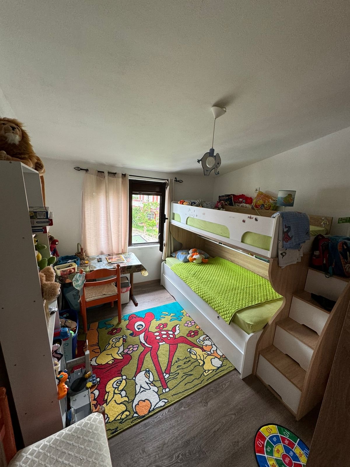 Bright, inviting kids&rsquo; room in Ulcinj features bunk bed, playful rugs, and natural light&mdash;prime real estate by ekosphere doo.