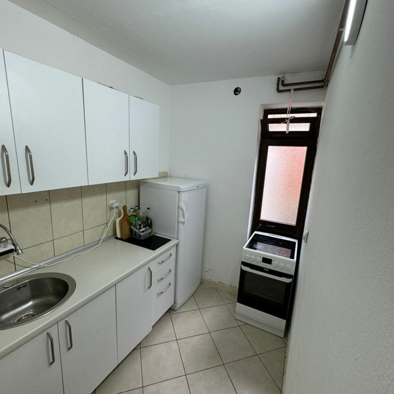 Bright, modern kitchen in Ulcinj, Montenegro with white cabinets and appliances; listed on immorenta.me by Ekosphere DOO.