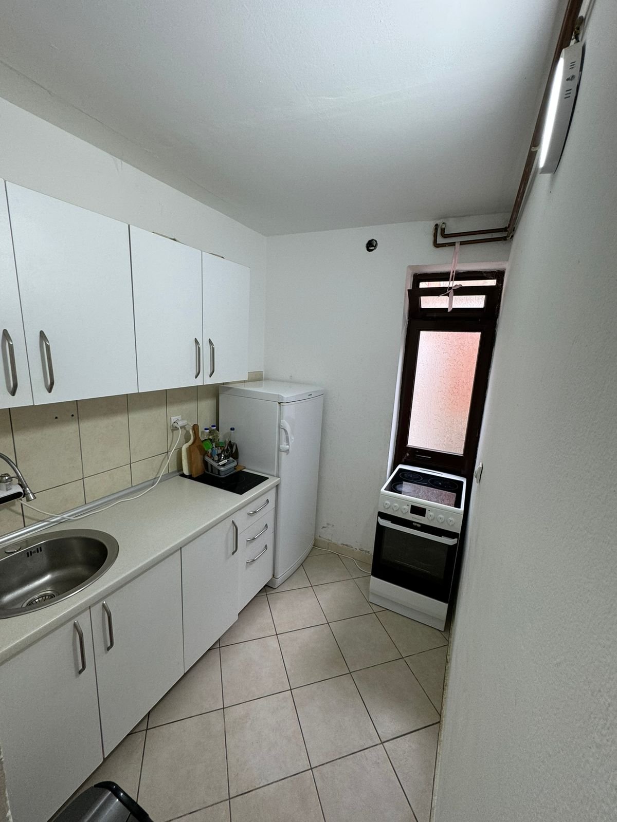 Bright, modern kitchen in Ulcinj, Montenegro with white cabinets and appliances; listed on immorenta.me by Ekosphere DOO.