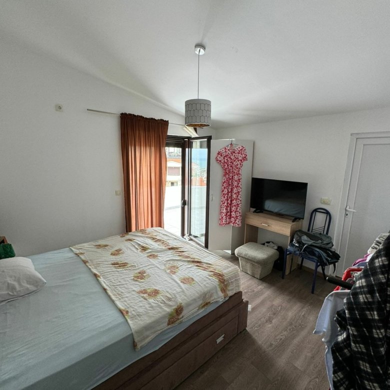 Modern Ulcinj bedroom with wooden floors, double bed, balcony, TV&mdash;prime real estate by Ekosphere doo at immorenta.me.