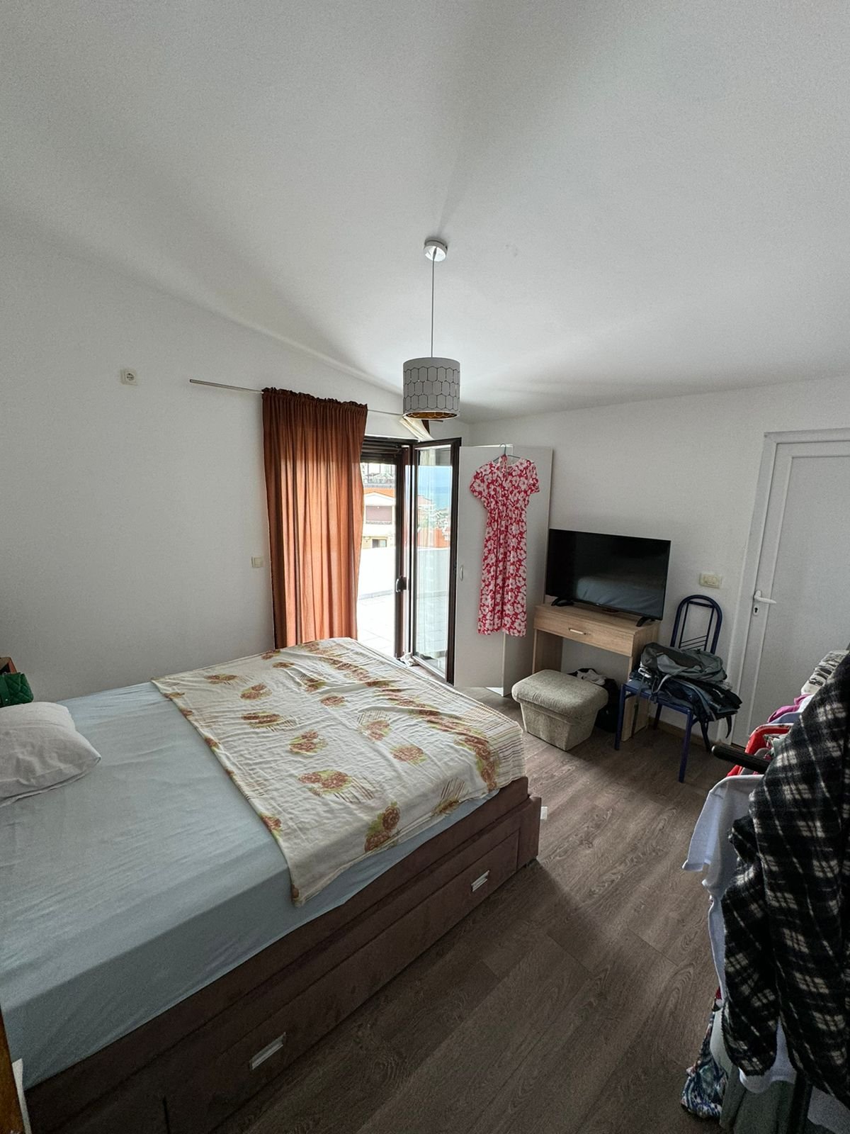 Modern Ulcinj bedroom with wooden floors, double bed, balcony, TV&mdash;prime real estate by Ekosphere doo at immorenta.me.