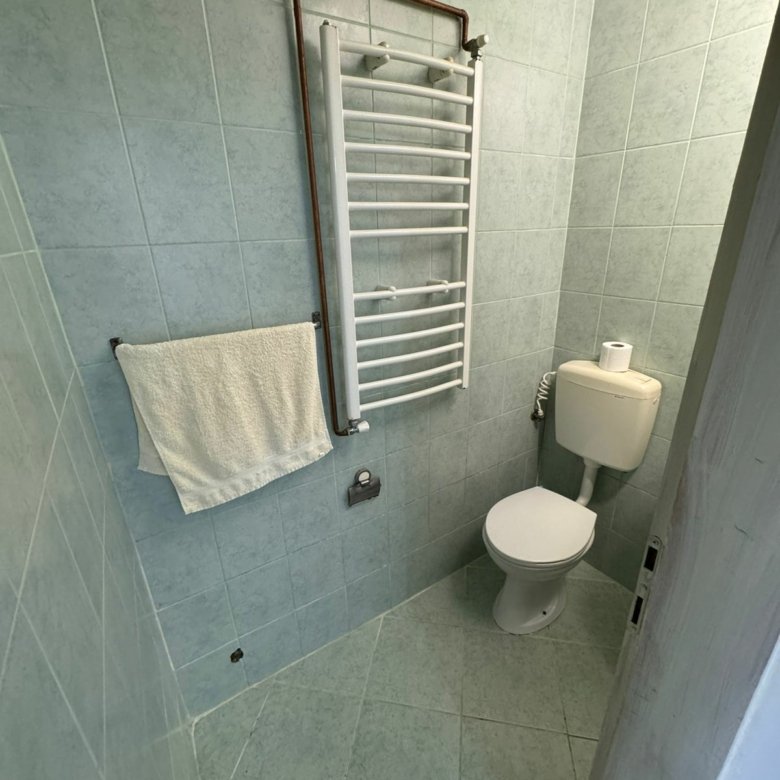 Modern Ulcinj bathroom with light green tiles, sleek fixtures&mdash;prime Montenegro real estate. Listed on immorenta.me by Ekosphere.
