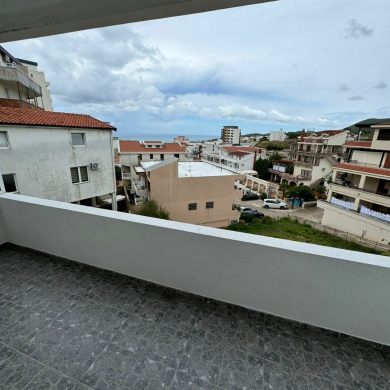 Stunning tiled balcony view over Ulcinj, Montenegro rooftops and sea&mdash;exclusive listings by Montenegro-Listings.me, a project of Ekosphere DOO.