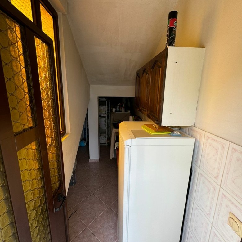 Modern Ulcinj laundry room with quality tiles, washer, and cabinets&mdash;a valuable rarity in Montenegro homes by Ekosphere DOO.