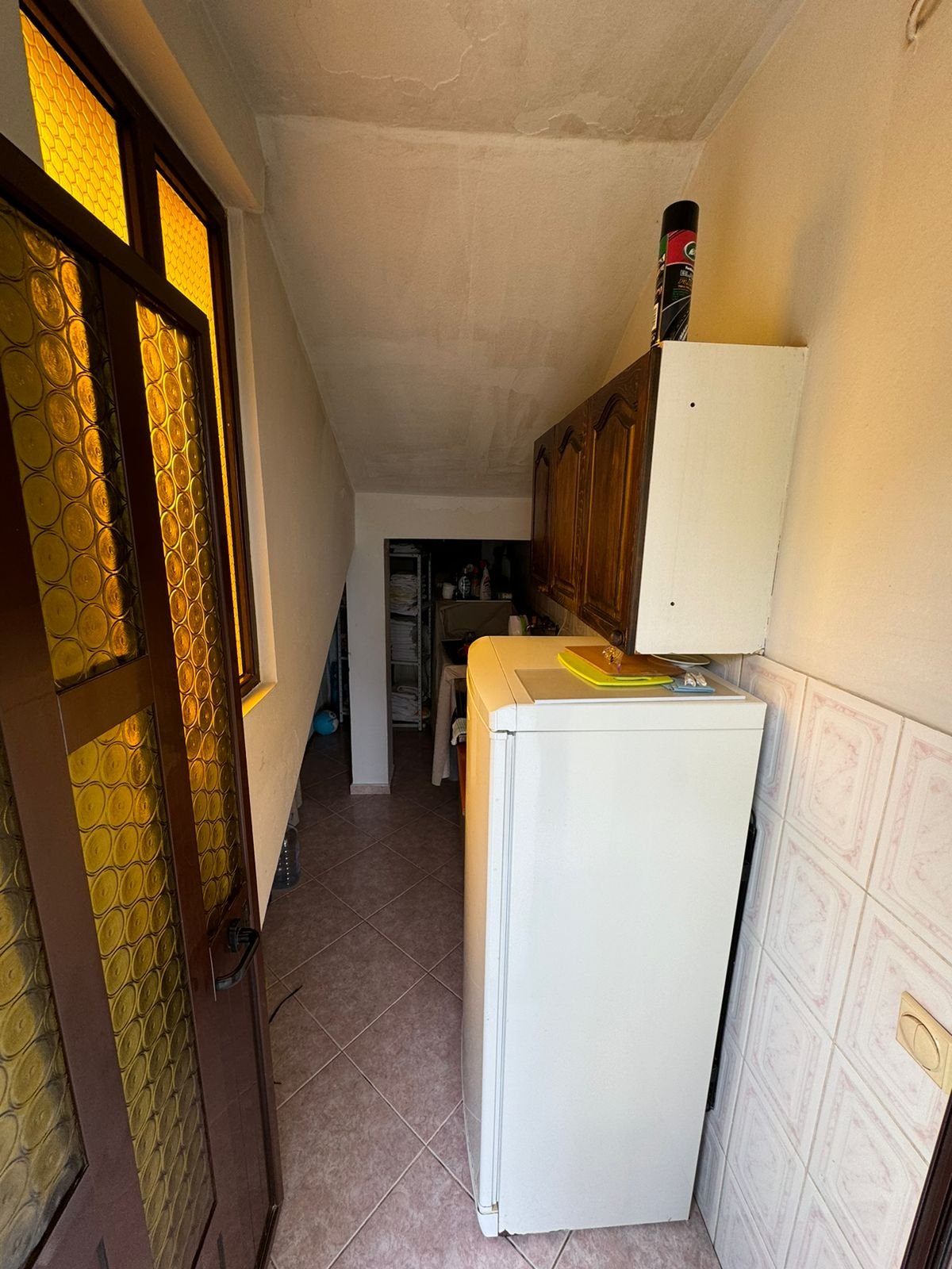 Modern Ulcinj laundry room with quality tiles, washer, and cabinets&mdash;a valuable rarity in Montenegro homes by Ekosphere DOO.