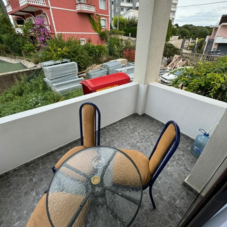 Stylish Ulcinj balcony with garden view, glass table, and nearby VANITA home&mdash;prime investment property at immorenta.me by ekosphere doo.