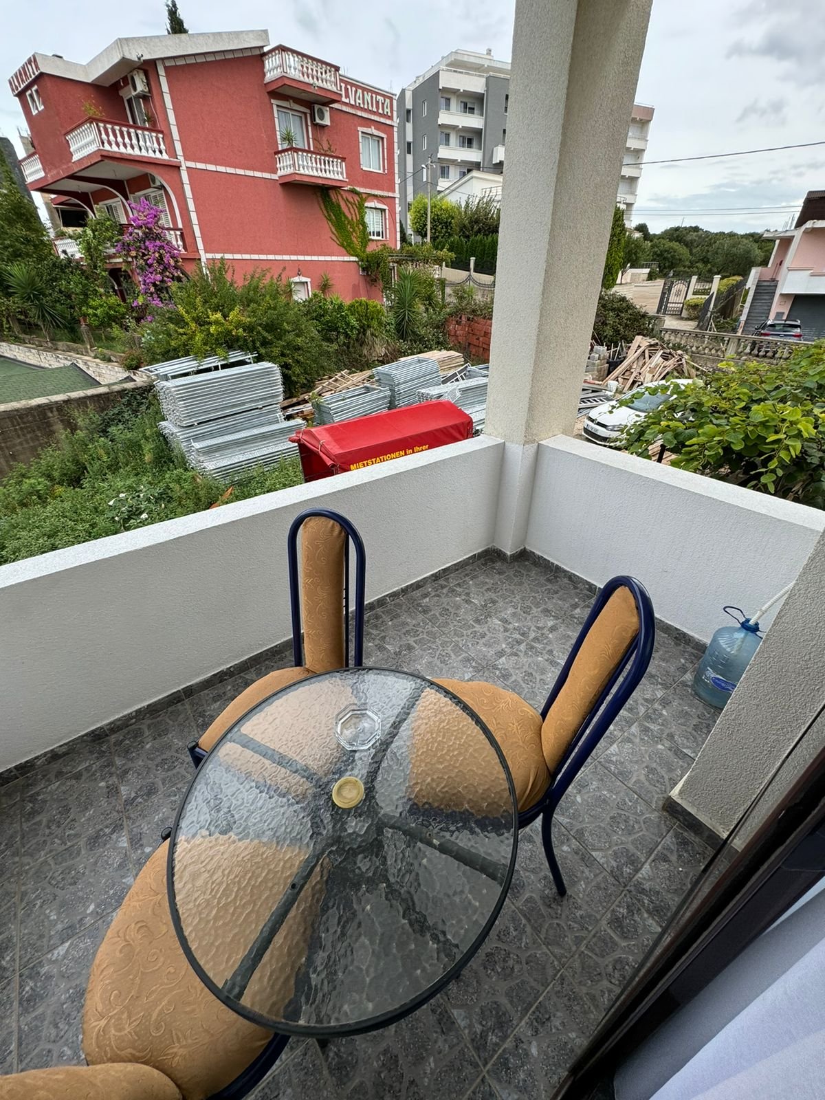 Stylish Ulcinj balcony with garden view, glass table, and nearby VANITA home&mdash;prime investment property at immorenta.me by ekosphere doo.