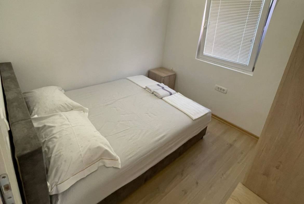 Charming Ulcinj bedroom with double bed, bright floors, and modern touches&mdash;ideal Montenegro real estate by immorenta.me/ekosphere.