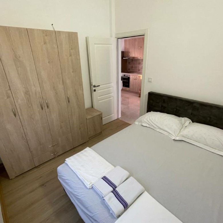 Charming Ulcinj Montenegro property: stylish small bedroom with wood floors, double bed, wardrobe&mdash;ideal investment at immorenta.me by ekosphere doo.