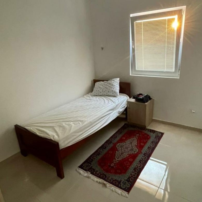 Charming Ulcinj bedroom with natural light, modern accents, ideal Montenegro property investment. Listed on immorenta.me by ekosphere doo.