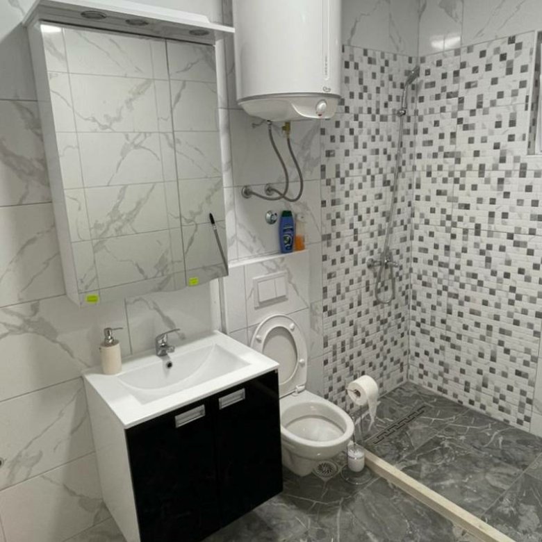 Modern Ulcinj bathroom with marble tile, luxury fixtures, and mosaic shower&mdash;prime real estate by immorenta.me (ekosphere doo).