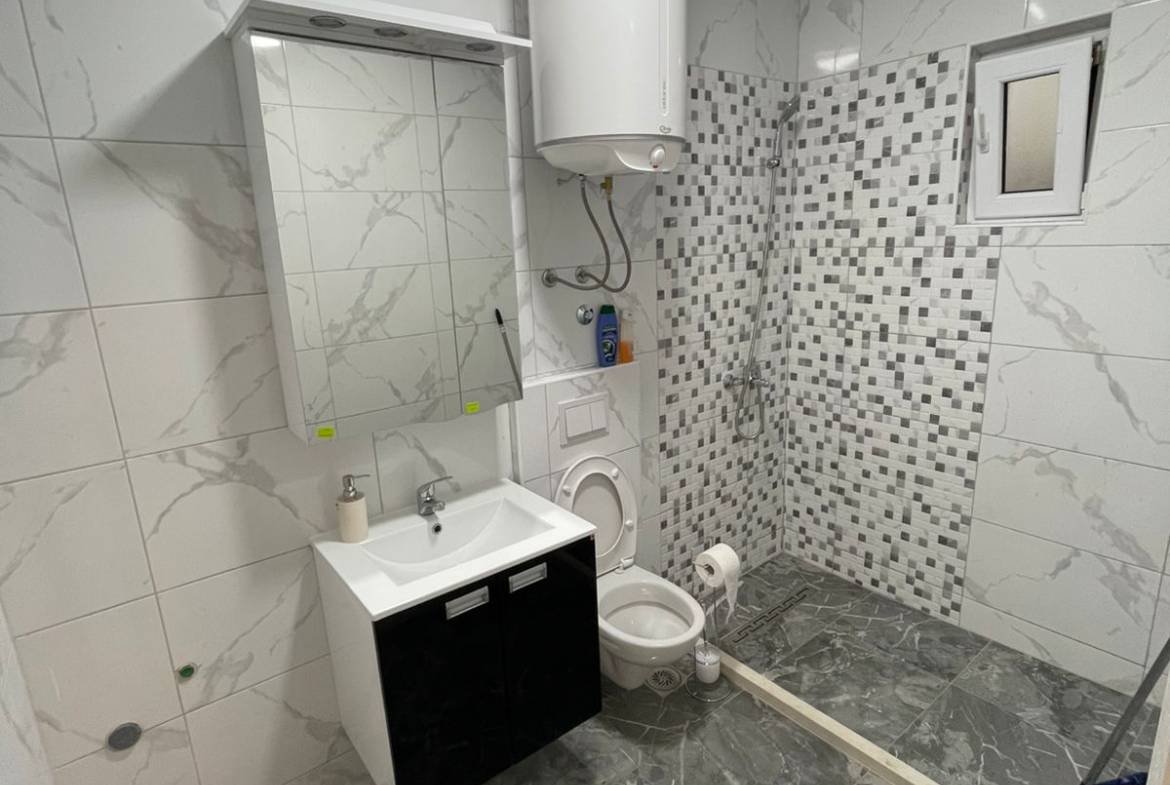 Modern Ulcinj bathroom with marble tile, luxury fixtures, and mosaic shower&mdash;prime real estate by immorenta.me (ekosphere doo).