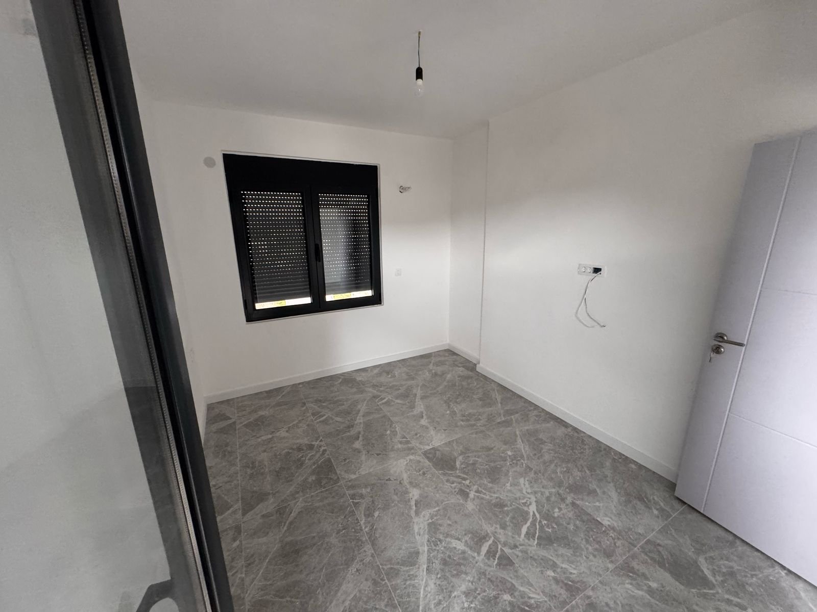 Spacious, bright room in Ulcinj, Montenegro&mdash;marble-tiled floor, white walls. Top real estate by Ekosphere on immorenta.me.