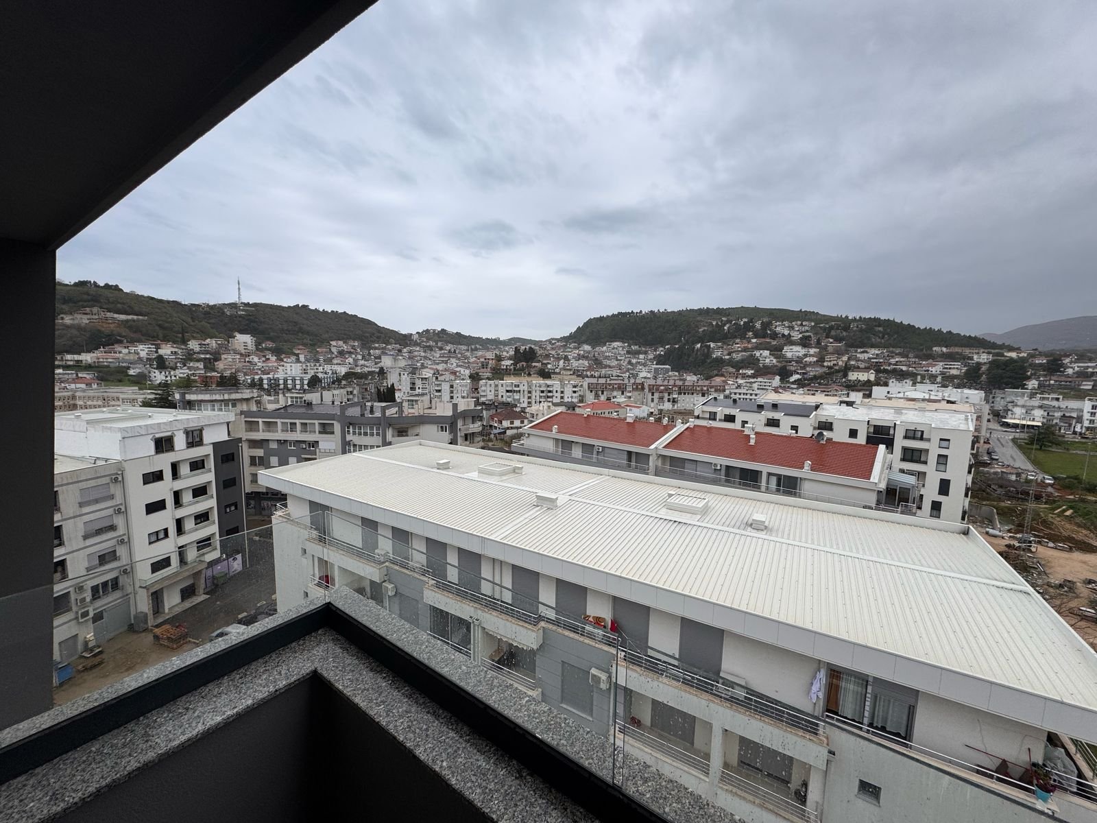 Panoramic balcony view of Ulcinj real estate&mdash;modern homes, investment opportunities, scenic hills. Montenegro-listings.me by ekosphere doo.