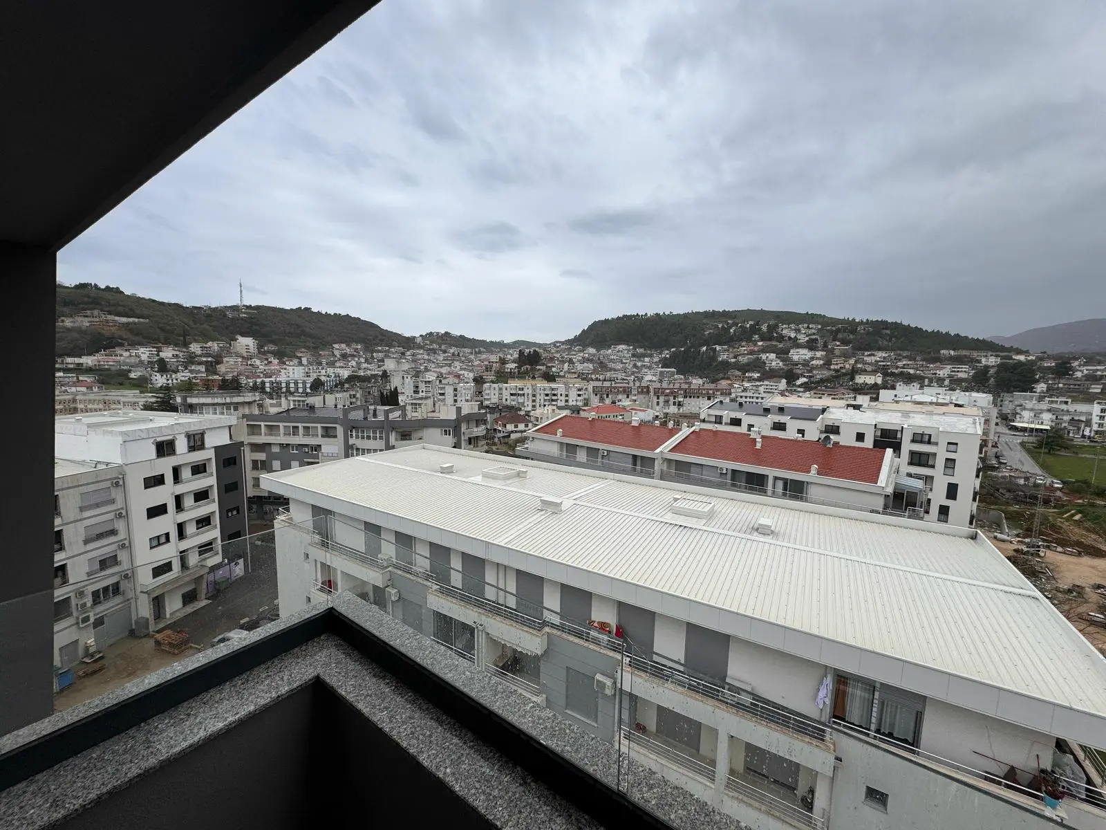 Panoramic balcony view of Ulcinj real estate&mdash;modern homes, investment opportunities, scenic hills. Montenegro-listings.me by ekosphere doo.