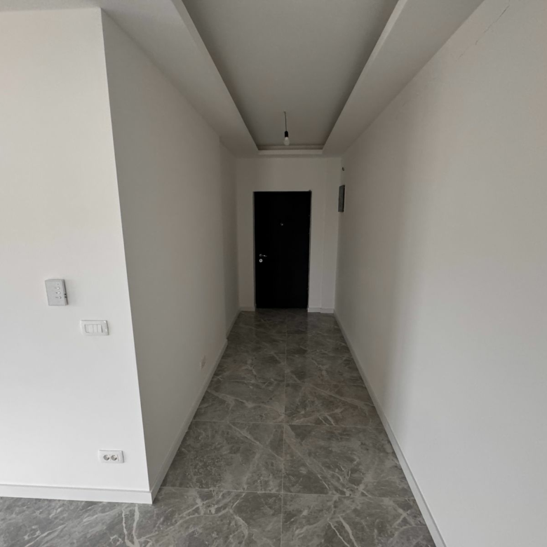Stylish Ulcinj property hallway with white walls, marble floor, modern fixtures. Exclusive at immorenta.me by ekosphere doo.
