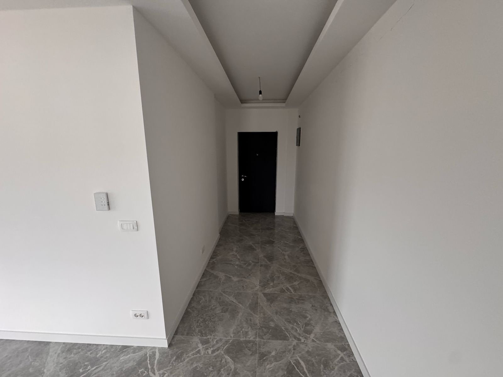 Stylish Ulcinj property hallway with white walls, marble floor, modern fixtures. Exclusive at immorenta.me by ekosphere doo.