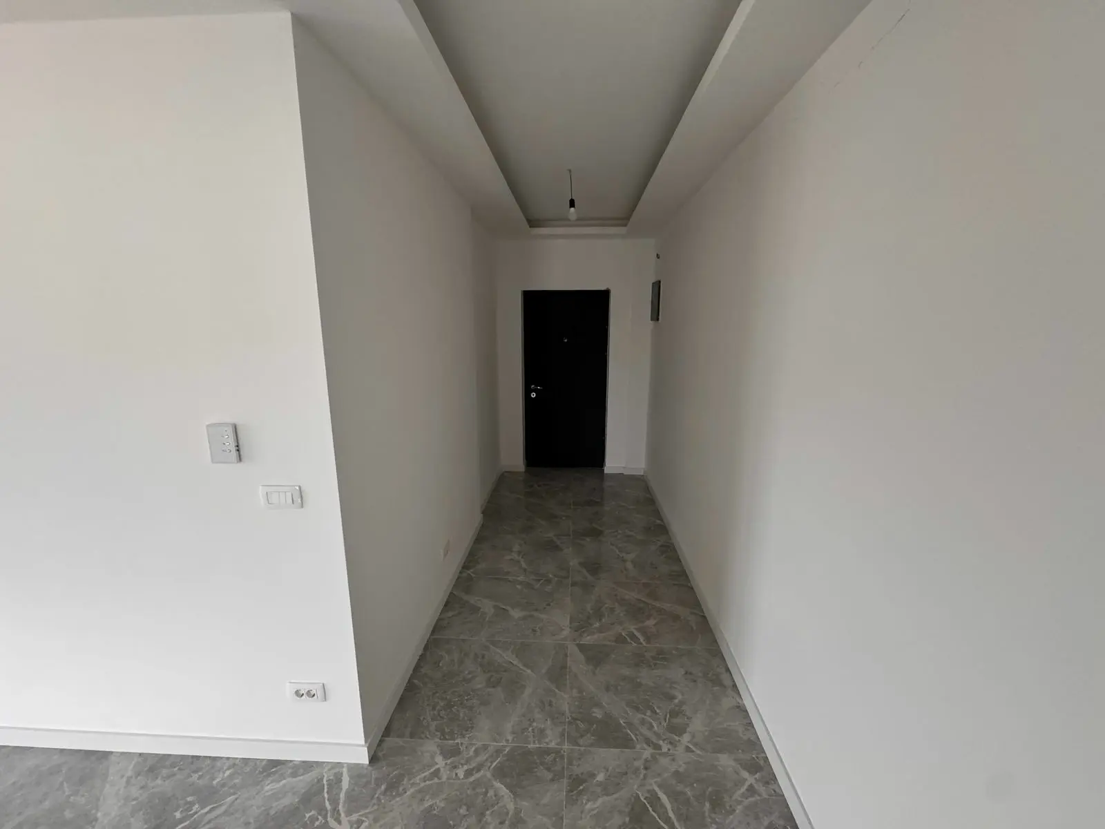 Stylish Ulcinj property hallway with white walls, marble floor, modern fixtures. Exclusive at immorenta.me by ekosphere doo.