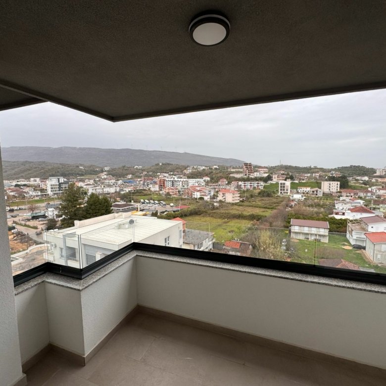 Stunning Ulcinj, Montenegro balcony view: prime real estate, lush hills, modern homes. Explore ekosphere&rsquo;s listings at Montenegro-Listings.me.