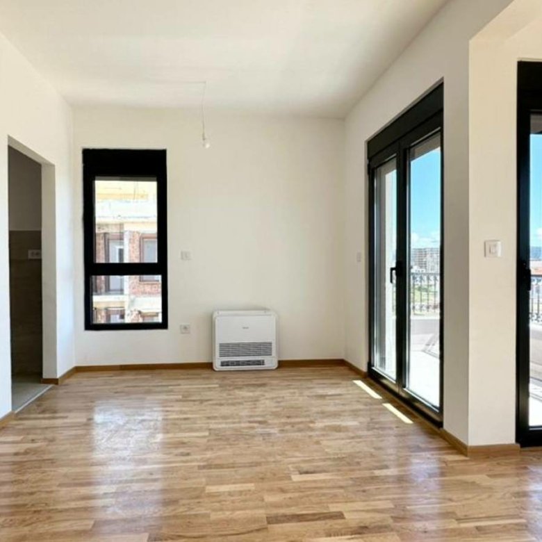 Spacious sunlit room with sleek floors, panoramic balcony views in Ulcinj&mdash;prime Montenegro real estate via immorenta.me by ekosphere doo.