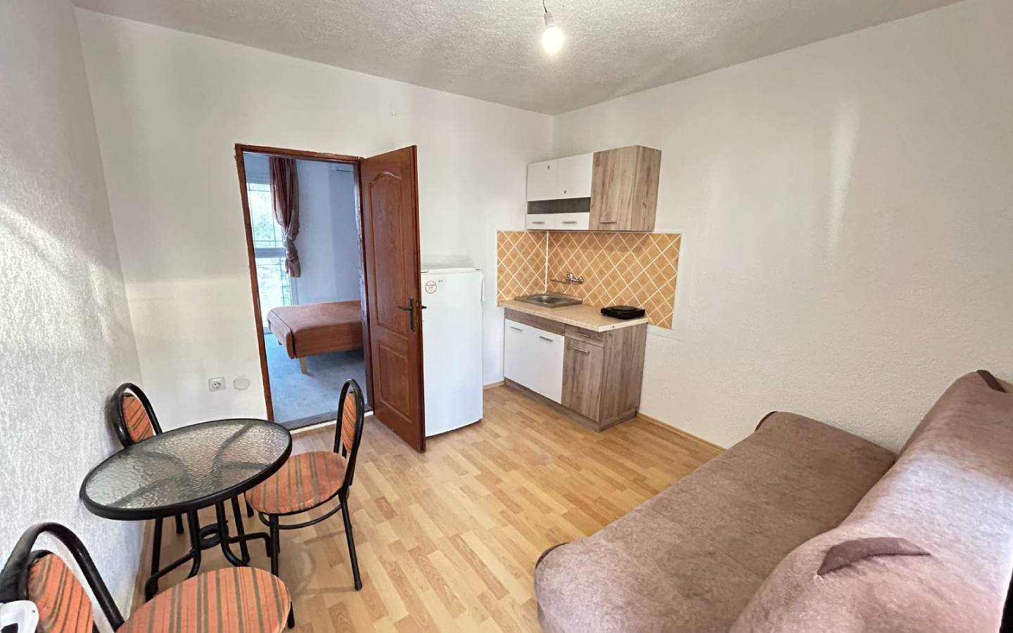 Stylish Ulcinj apartment: kitchenette, dining area, sofa, private bedroom. Top real estate investment via immorenta.me/Ekosphere doo.