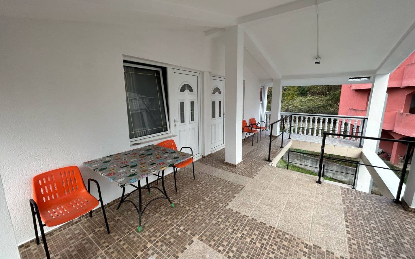 Stylish covered patio in Ulcinj, Montenegro&mdash;tiled floors, modern seating, ideal property investment on immorenta.me by ekosphere doo.