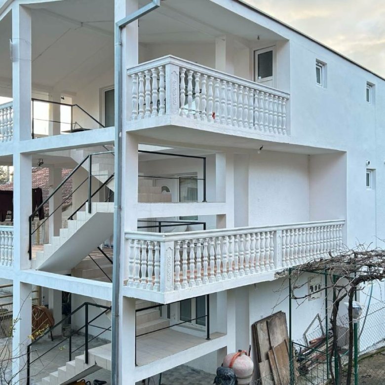 Modern three-story white home in Ulcinj, Montenegro with balconies and lush trees&mdash;exclusive listing on immorenta.me by ekosphere doo.