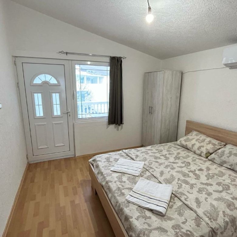 Charming Ulcinj bedroom for sale: double bed, AC, wardrobe, bright windows&mdash;prime Montenegro real estate via immorenta.me.