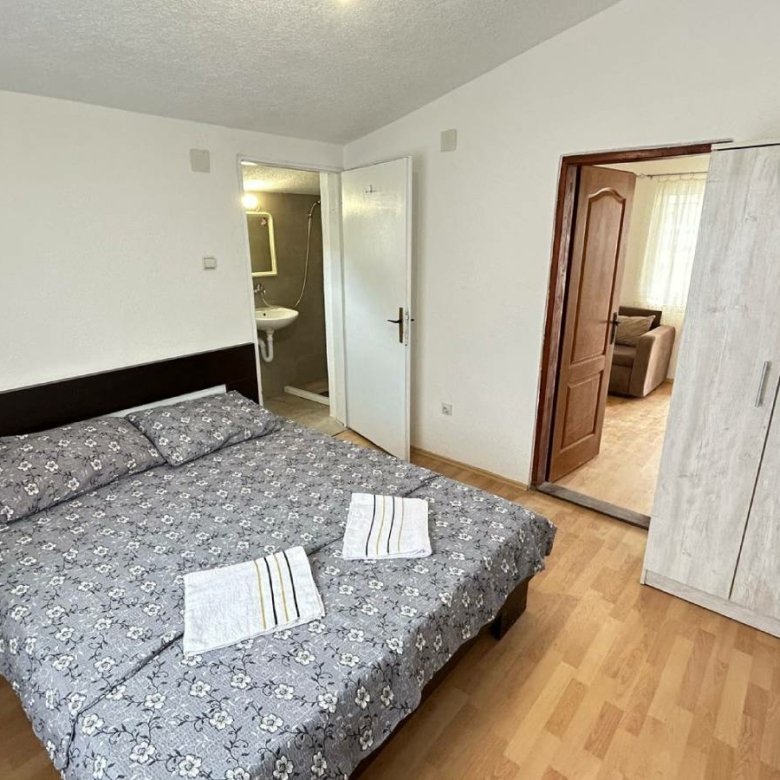 Elegant Ulcinj bedroom with floral double bed, ample storage, private bathroom; top investment on immorenta.me by Ekosphere.