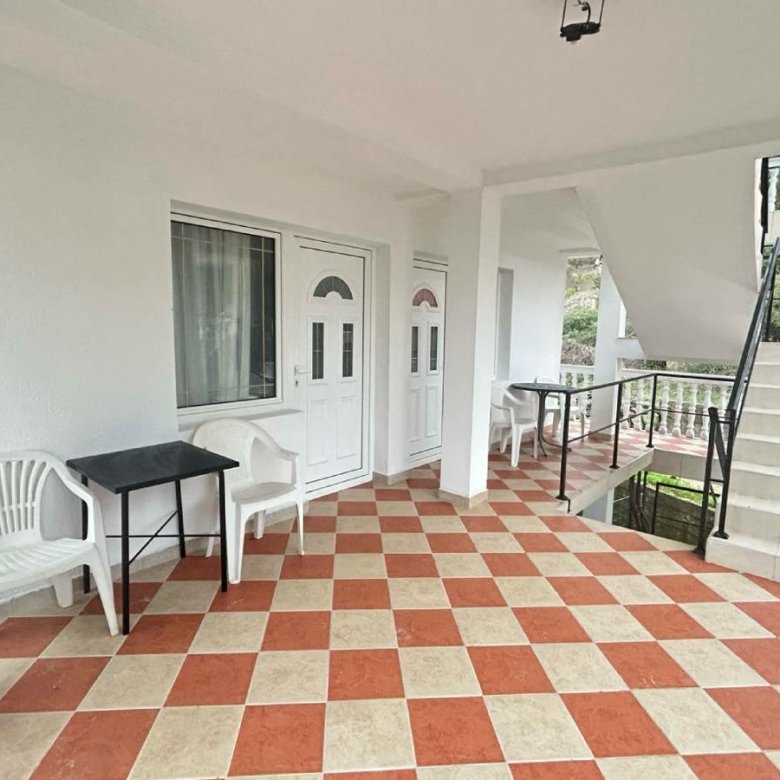 Discover this Ulcinj, Montenegro property: covered corridor, stylish checkered floor, modern seating&mdash;exclusive on immorenta.me.