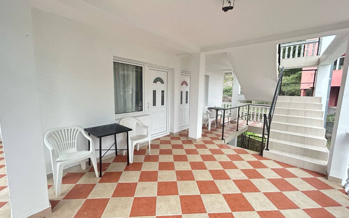 Discover this Ulcinj, Montenegro property: covered corridor, stylish checkered floor, modern seating&mdash;exclusive on immorenta.me.