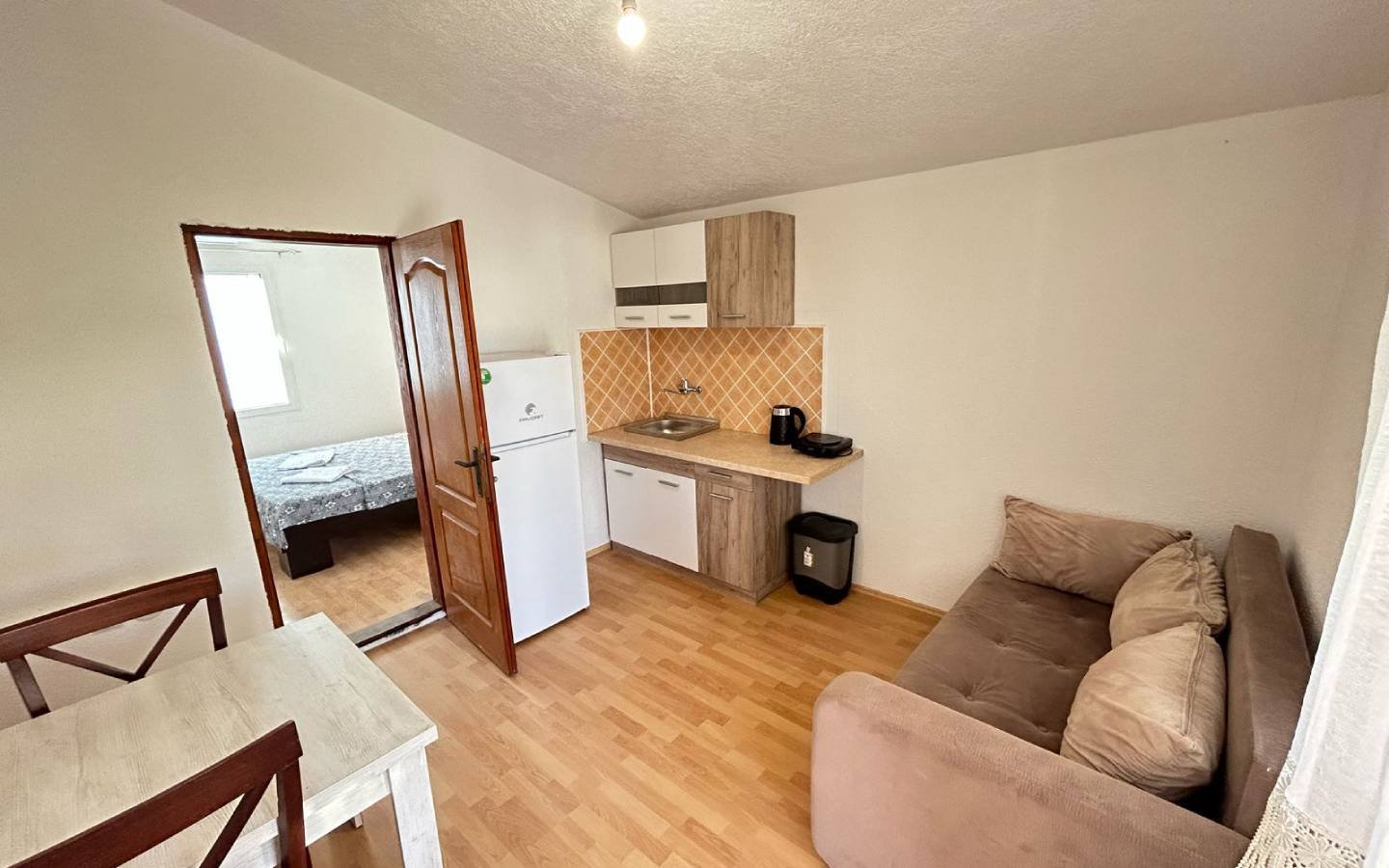 Modern Ulcinj apartment with kitchenette, dining area, and bedroom&mdash;ideal Montenegro real estate by Ekosphere on immorenta.me.