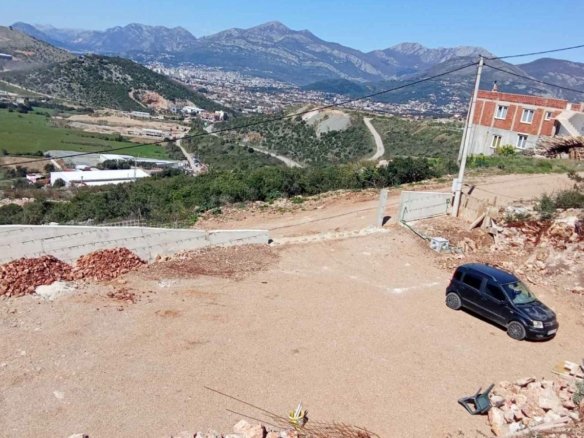 Prime Ulcinj, Montenegro investment: half-built home, gravel parking, mountain views. Listed by immorenta.me (ekosphere doo).