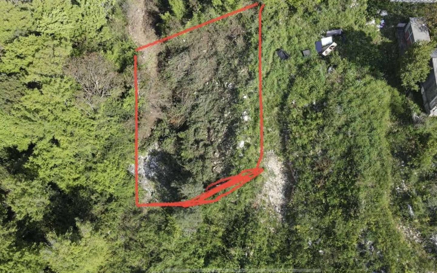 Prime real estate plot in Ulcinj, Montenegro&mdash;outlined area amid lush greenery. Investment potential via immorenta.me (ekosphere doo).