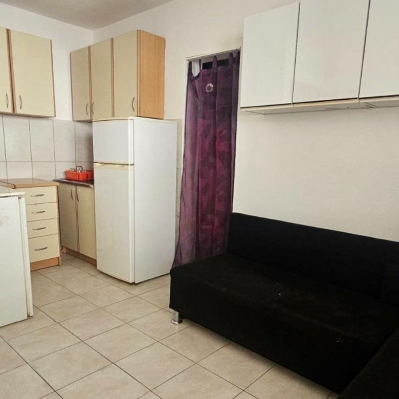 Modern Ulcinj apartment: light cabinets, tiled floors, L-shaped sofa. Invest in eco-friendly living&mdash;immorenta.me by ekosphere doo.