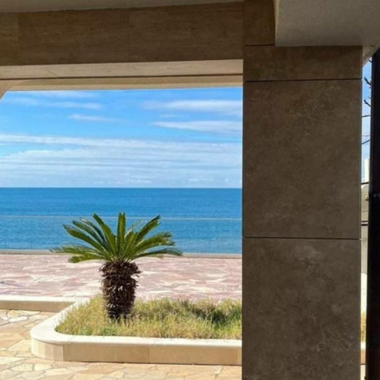 Stunning Ulcinj Montenegro property: ocean views through a stone arch, palm patio, by Ekosphere on immorenta.me.