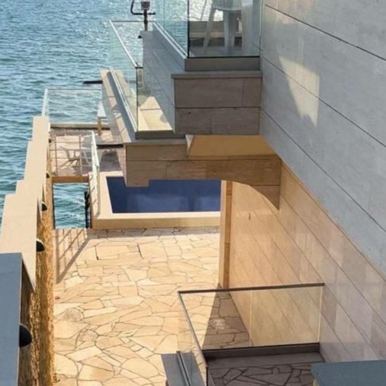 Waterfront modern home in Ulcinj with pool, stone patio, and glass railings&mdash;exclusive at immorenta.me by Ekosphere d.o.o.