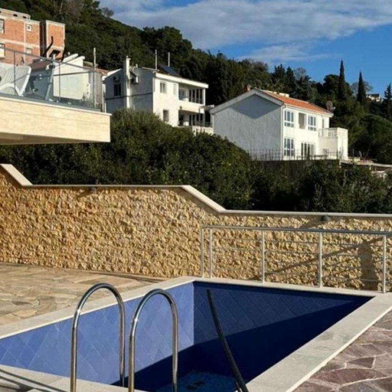 Stunning Ulcinj villa with private pool on a stone patio, glass railing, hillside views. Prime Montenegro investment via ekosphere doo.