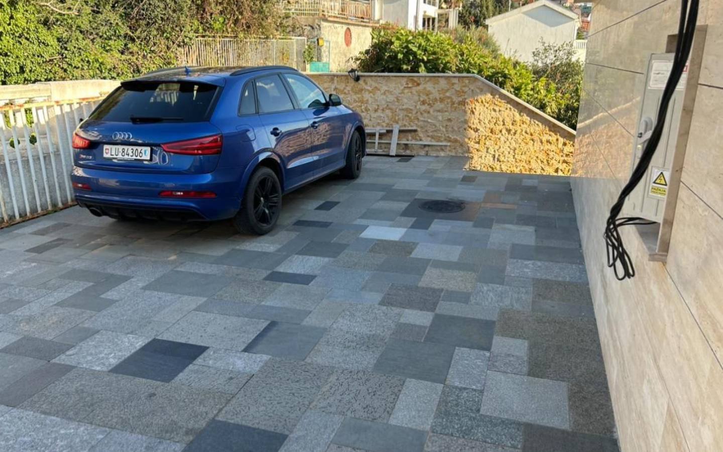 Modern Ulcinj property with EV charger, tiled drive, luxury SUV, greenery&mdash;exclusive from Ekosphere Montenegro-Listings.me.