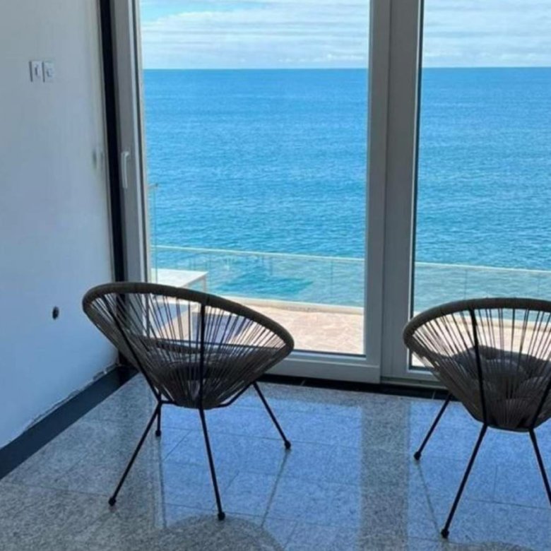 Stunning Ulcinj apartment: panoramic ocean views, elegant wicker seating, tiled floors&mdash;exclusive listing from ekosphere doo at immorenta.me.