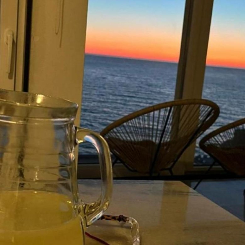 Elegant indoor setting featuring a glass pitcher, with balcony ocean sunset views&mdash;ideal Ulcinj investment. immorenta.me by ekosphere doo.