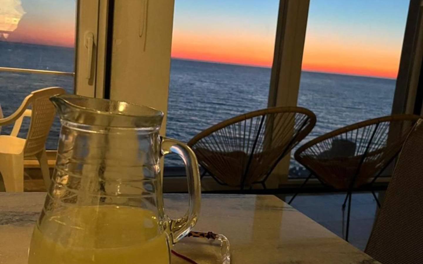 Elegant indoor setting featuring a glass pitcher, with balcony ocean sunset views&mdash;ideal Ulcinj investment. immorenta.me by ekosphere doo.