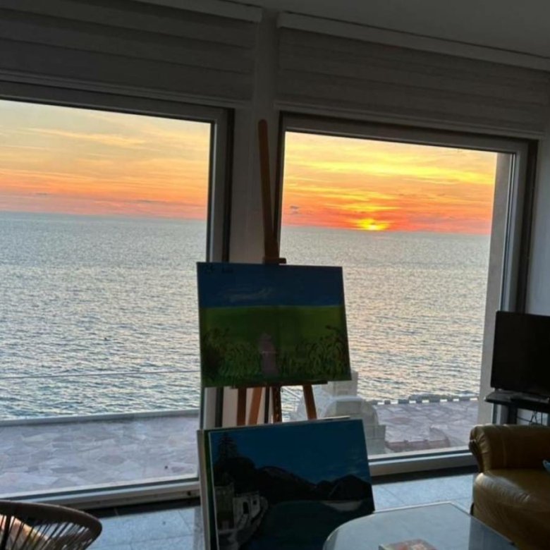 Stunning Ulcinj sea-view living room with sunset vistas, bright windows, art accents. Exclusive Ekosphere DOO listing on immorenta.me.