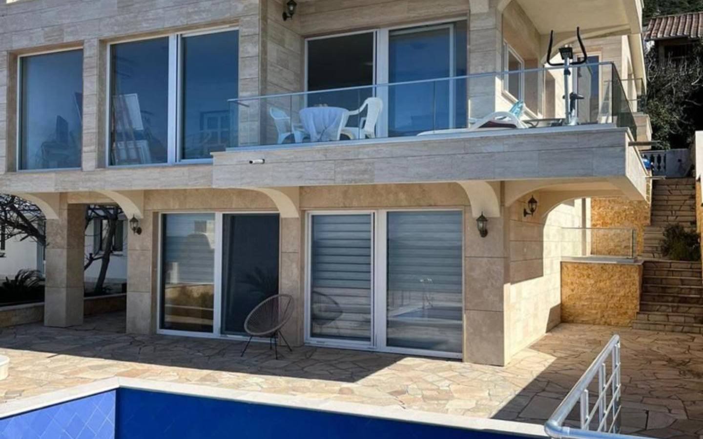 Contemporary two-story home in Ulcinj, Montenegro with glass doors, balcony, stone patio, pool&mdash;prime investment via immorenta.me.
